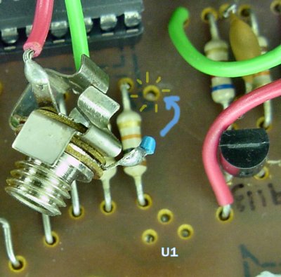 Three holes for the missing transistor (labeled U1 here) and one hole for the missing wire on the expansion plug port on the Big Trak.