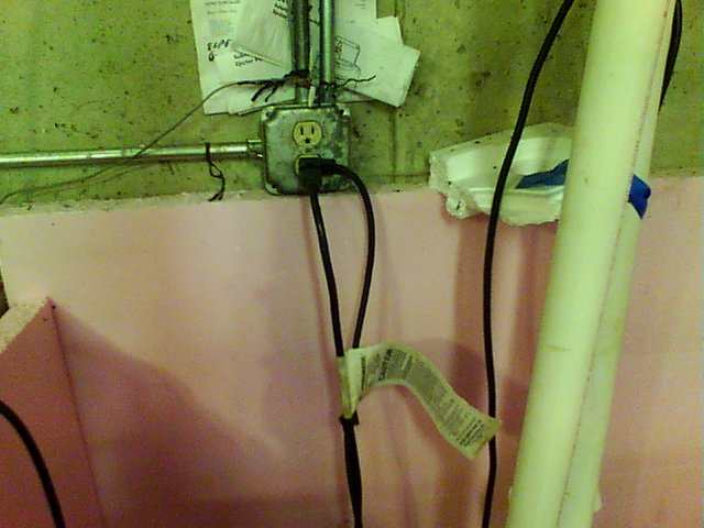 Sump pump electrical cable visible