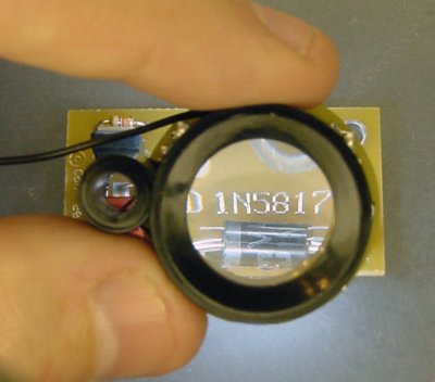 Lighted magnifier demonstrating its effectiveness on a PCB.