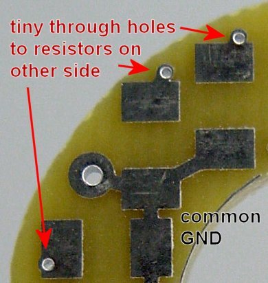 Tiny plated-through holes or vias connect component pads from one PCB side to the other.