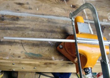 Cutting down long rod stock with a hacksaw.
