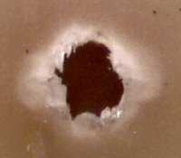 Poorly drilled PCB hole at 60x magnification