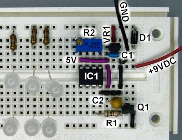 Solderless breadboard layout with pulsing blue LED lighting controlled by an Atmel ATTiny45 microcontroller.