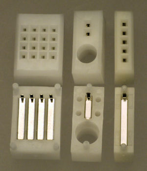 Tiny breadboards (overhead view on the top of the photo, underneath view on the bottom of the photo).
