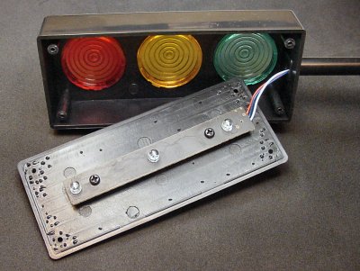 Traffic light project box showing color filters and a circuit board.