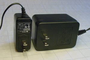 A modern commercial ac adapter switching power supply (left side) is cheaper, smaller, lighter, better oriented, and more efficient than the previous generation of linear wall warts (right side).