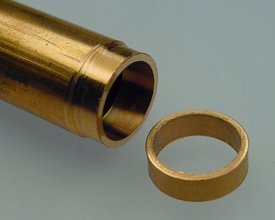 A metal ring cut from a copper tube with the outer diameter reduced in a lathe.