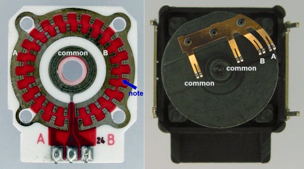 Inside a mechanical rotary encoder showing the PCB and brushes.