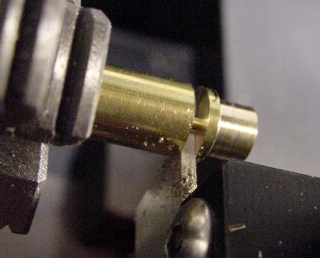 Parting a one-piece brass button with a rear flange.