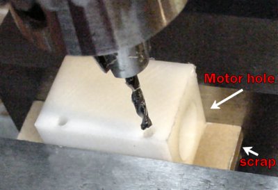 Drilling two holes in the side of the motor mount.