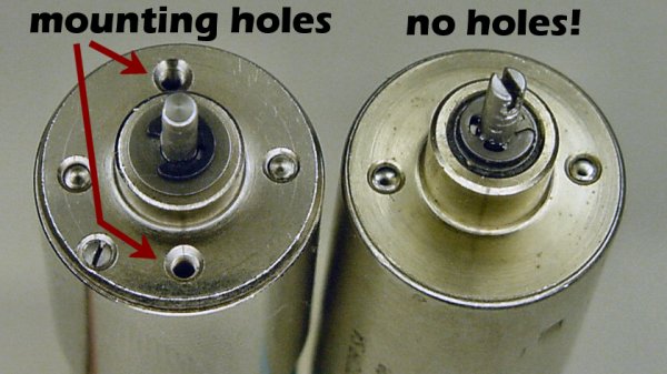 Two similar miniature electric motors. The motor on the right doesn’t have any mounting holes.