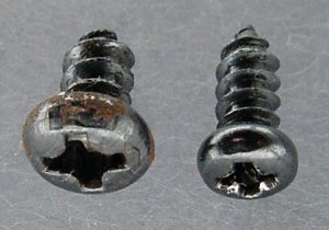 Two sizes of small, pan-head, phillips-drive, sheet-metal screws.